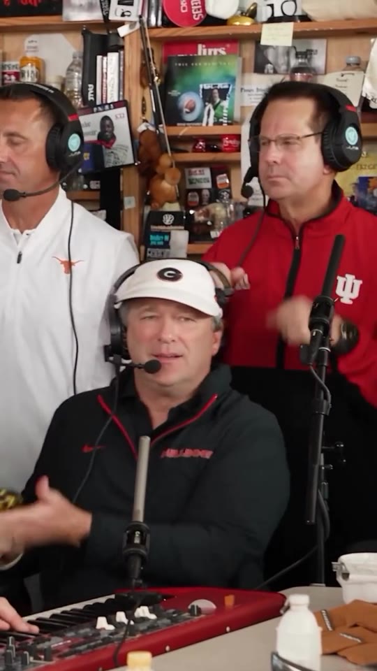 Outstanding Tiny Desk meme, first shot: two singers stand behind a singer at a red keyboard, all in headphones