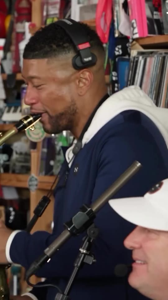 Outstanding Tiny Desk meme, last shot: a saxophone solo in front of the bookshelves