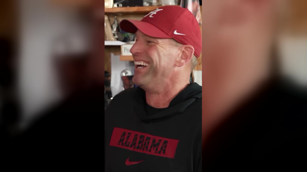 The All-Loss Tiny Desk Concert: a coach in a crimson cap laughing in headphones